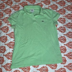 A Lacoste polo that is a mint green color.